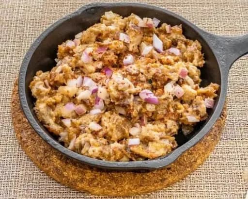 Sizzling Pork Sisig on cast iron plate